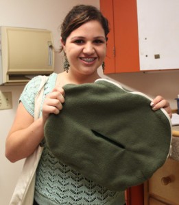 Intern Victoria holds a pouch that is designed to mimic the pouch of a marsupial. The fabric is extremely soft and keeps the baby warm. The pouch is also seamless to prevent the newborn from ingesting any loose fabric.