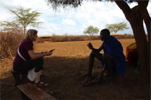 Christine Brown-Nunez, PhD a human dimensions of conservation specialist talking about wildlife interactions with a maasai warrior just outside Amboseli National Park.